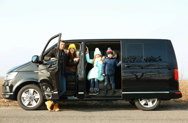 Happy family with little children in modern car on road — 스톡 사진