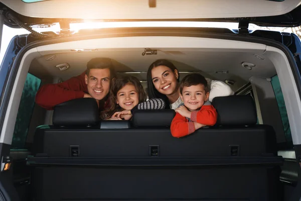 Famille heureuse avec de petits enfants dans une voiture moderne — Photo