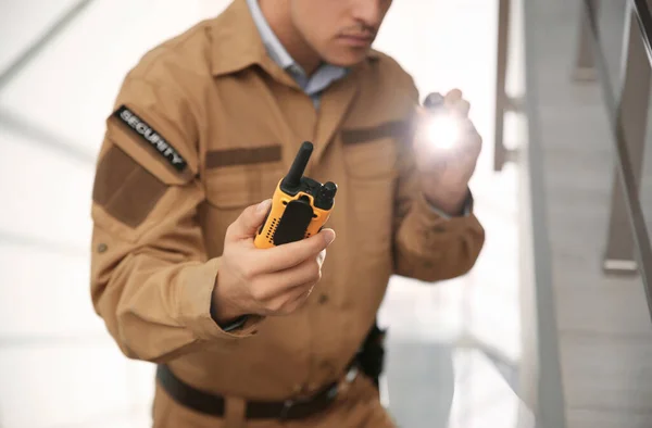Professional security guard with portable radio set and flashlig — Stock Photo, Image