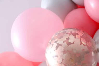 Beautiful colorful balloons on light background, closeup