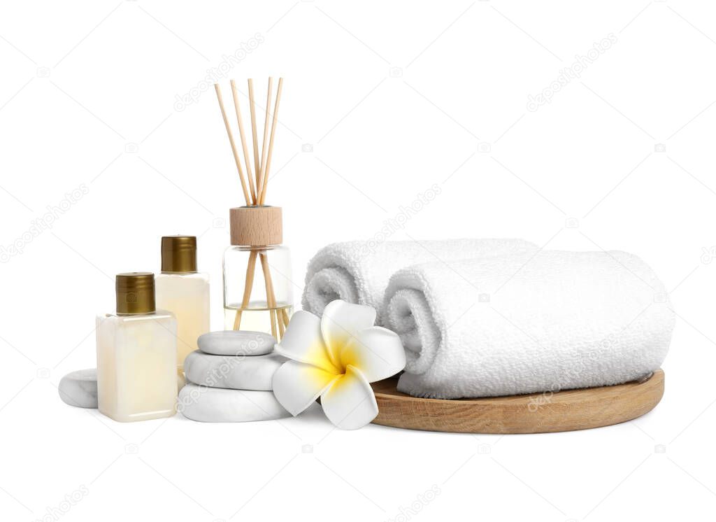 Beautiful spa composition with reed diffuser on white background