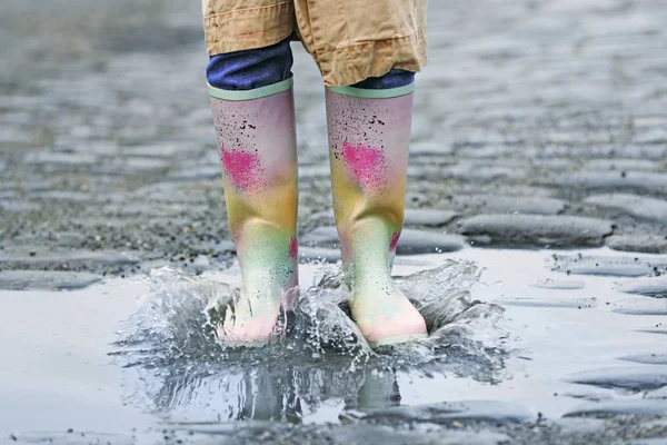 Woman in rubber boots walking outdoors on rainy day, closeup — Stok fotoğraf