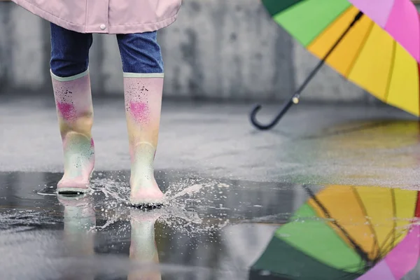 Woman in rubber boots walking outdoors on rainy day, closeup — ストック写真