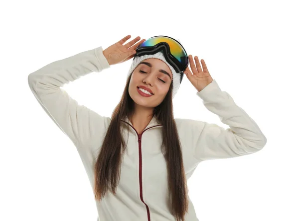 Woman wearing fleece jacket, hat and goggles on white background