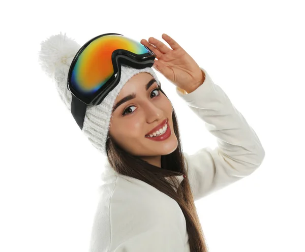 Woman wearing fleece jacket, hat and goggles on white background