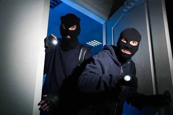 Thieves with flashlights breaking into house at night — 스톡 사진