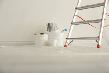 Stepladder and different tools near wall in room. Interior renov