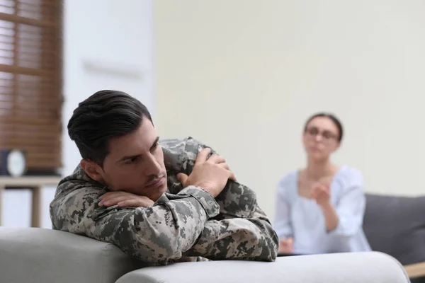 Male military officer having appointment with psychotherapist in