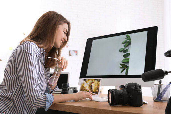 Professional photographer working at table in office