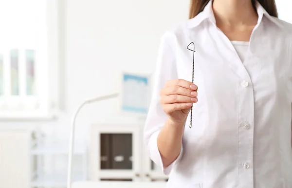 Speech therapist with logopedic probe in clinic, closeup. Space