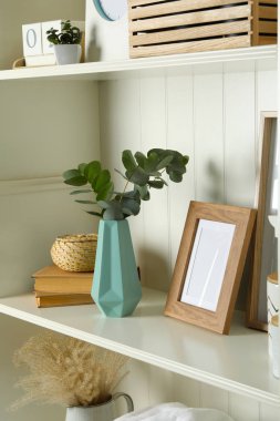White shelving unit with different decorative elements