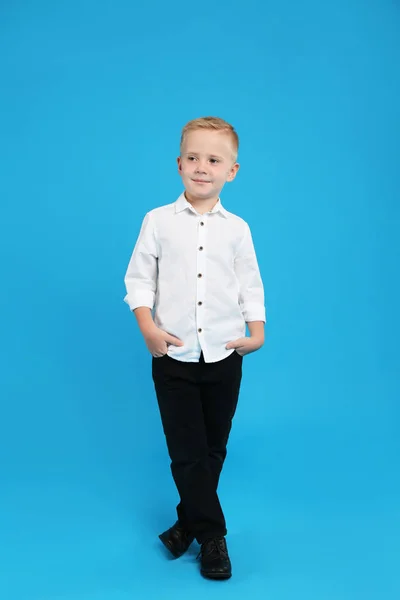 Full length portrait of cute little boy on light blue background — Stock Photo, Image