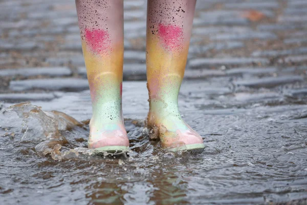 Woman in rubber boots walking outdoors on rainy day, closeup — ストック写真