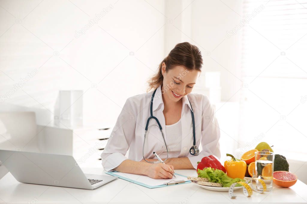 Female nutritionist working at desk in office