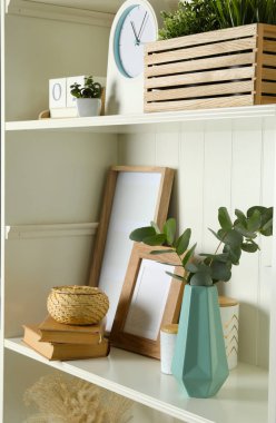 White shelving unit with different decorative elements