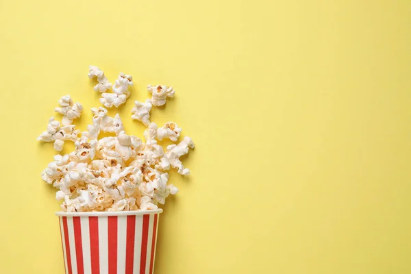 Delicious popcorn on yellow background, top view. Space for text — Stock Photo, Image