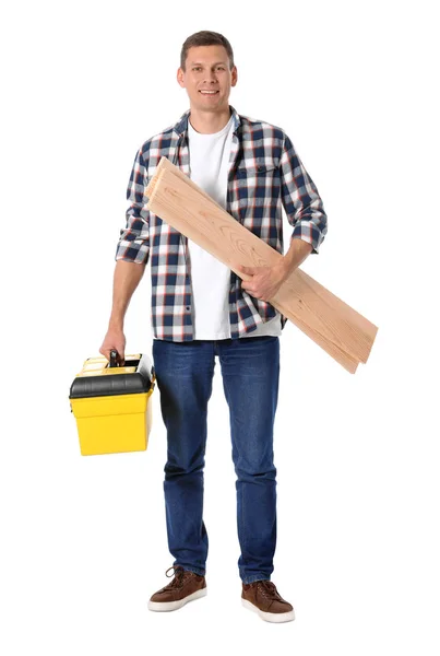 Handsome carpenter with wooden planks and tool box isolated on w — 스톡 사진