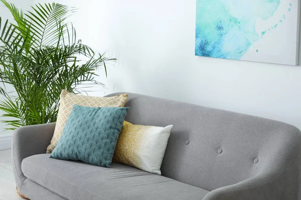 Diferentes almohadas suaves en el sofá en la sala de estar —  Fotos de Stock