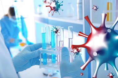 Bilim adamı, kapalı alanda sıvı içeren test tüpleri tutuyor. İşçi Partisi