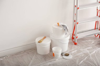 Stepladder and different tools near wall in room. Interior renov