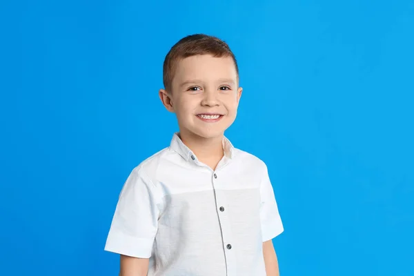 Портрет милого маленького хлопчика на синьому фоні — стокове фото