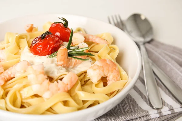 Delicious pasta with shrimps served on table, closeup
