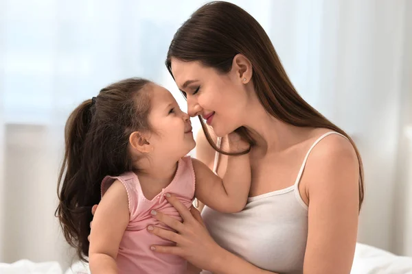 Happy mother with little daughter in bedroom — Stock Photo, Image