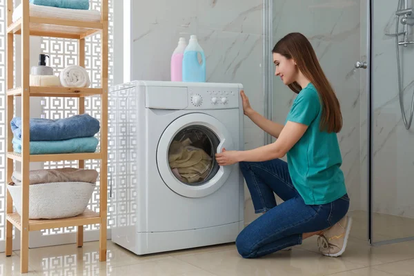 Woman near washing machine in bathroom. Laundry day — Stock Photo, Image