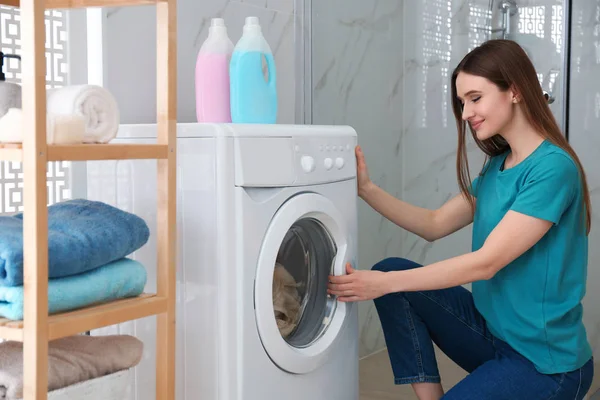 Woman near washing machine in bathroom. Laundry day — Stock Photo, Image