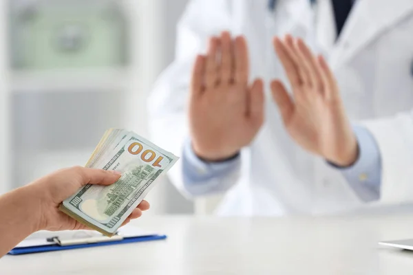 Doctor rejecting bribe in clinic, closeup. Corrupted medicine — Stock Photo, Image