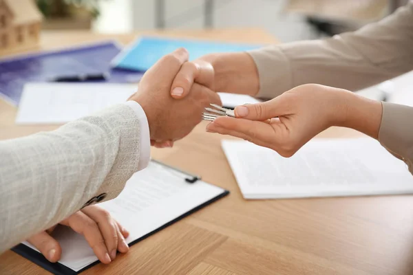 Real estate agent shaking hands with client in office, closeup — 스톡 사진