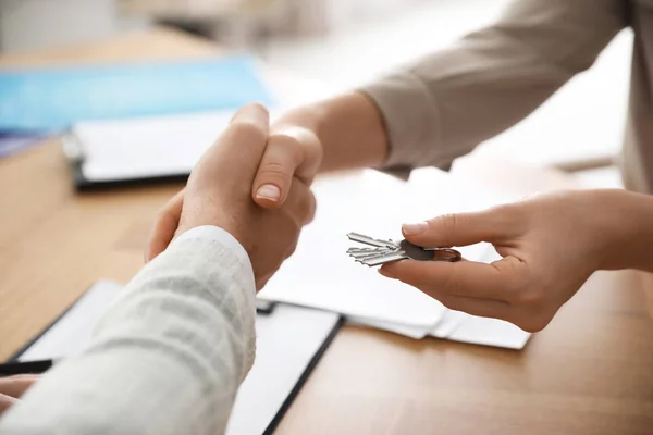 Real estate agent shaking hands with client in office, closeup — 스톡 사진