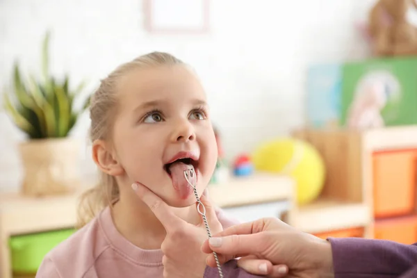 Speech therapist using logopedic probe on session with little gi — Stock Photo, Image