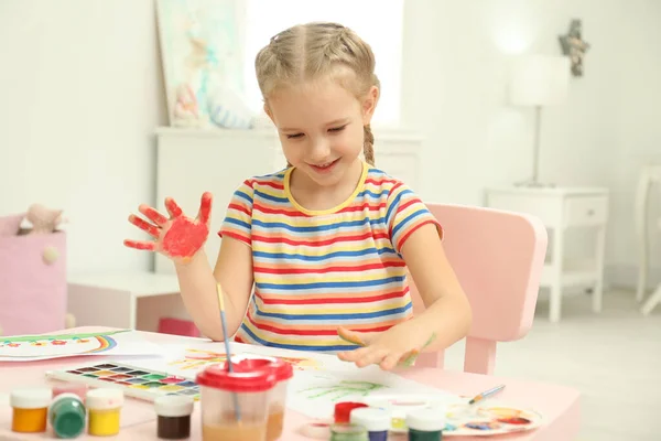 Cute little child painting with palms at table — 스톡 사진