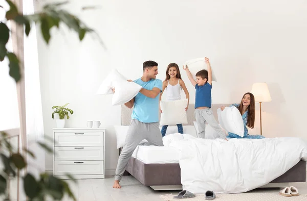 Glückliche Familie bei Kissenschlacht im Schlafzimmer — Stockfoto