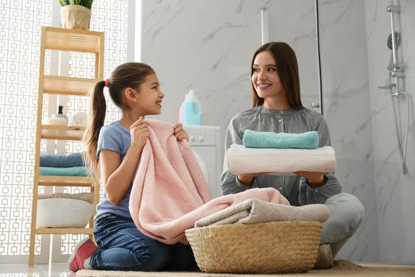 Matka i córeczka z czystym praniem w łazience — Zdjęcie stockowe