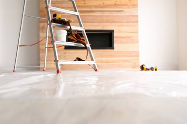 Stepladder and different tools in room. Interior renovation