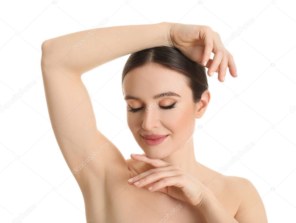 Young beautiful woman showing armpit with smooth clean skin on white background