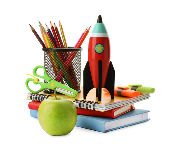 Bright toy rocket and school supplies on white background