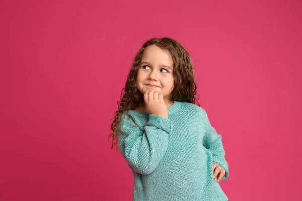 Portrait of cute little girl on pink background — Stok Foto