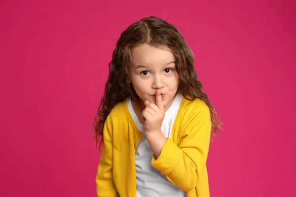 Portrait of cute little girl on pink background — Stok Foto