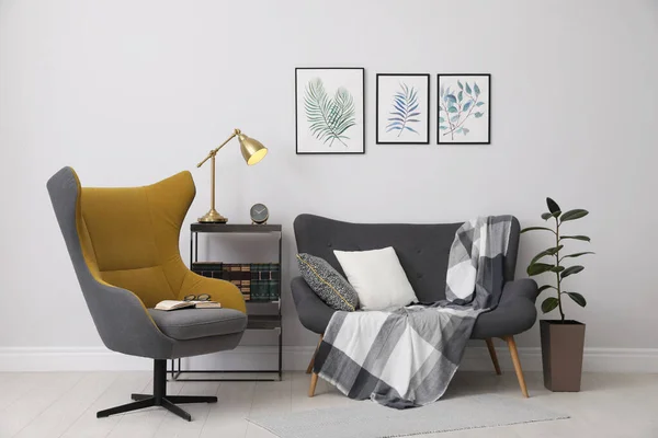 Interior elegante quarto com poltrona confortável, sofá e painti — Fotografia de Stock