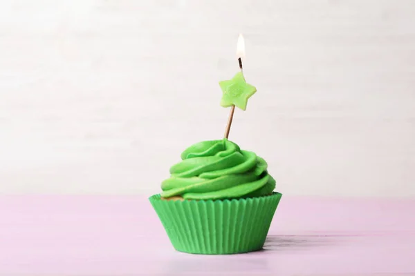 Delicioso Cupcake Cumpleaños Con Crema Vela Encendida Mesa Rosa — Foto de Stock