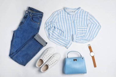 Stylish outfit with jeans on white background, top view