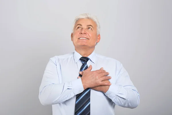Grateful Senior Man Hands Chest Light Grey Background — Stock Photo, Image