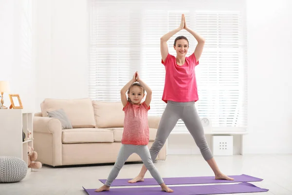 Mother and daughter doing yoga. woman and child training in the park.  outdoor sports. healthy sport lifestyle, chaturanga pose. well being,  mindfulness concept,watching video tutorial online on laptop 8497445 Stock  Photo at