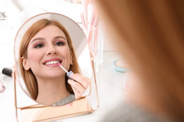Beautiful Young Woman Applying Makeup Mirror Indoors — Stock Photo, Image