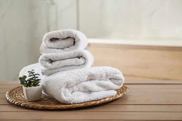 Clean Folded Towels Plant Wooden Table Bathroom Space Text — Stock Photo, Image