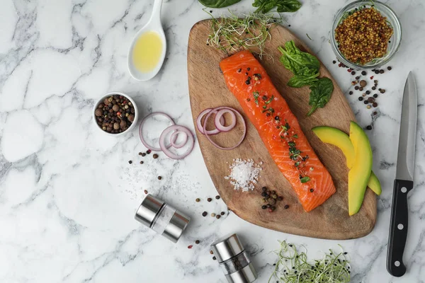 stock image Delicious salmon with spinach and avocado served on white marble table, flat lay