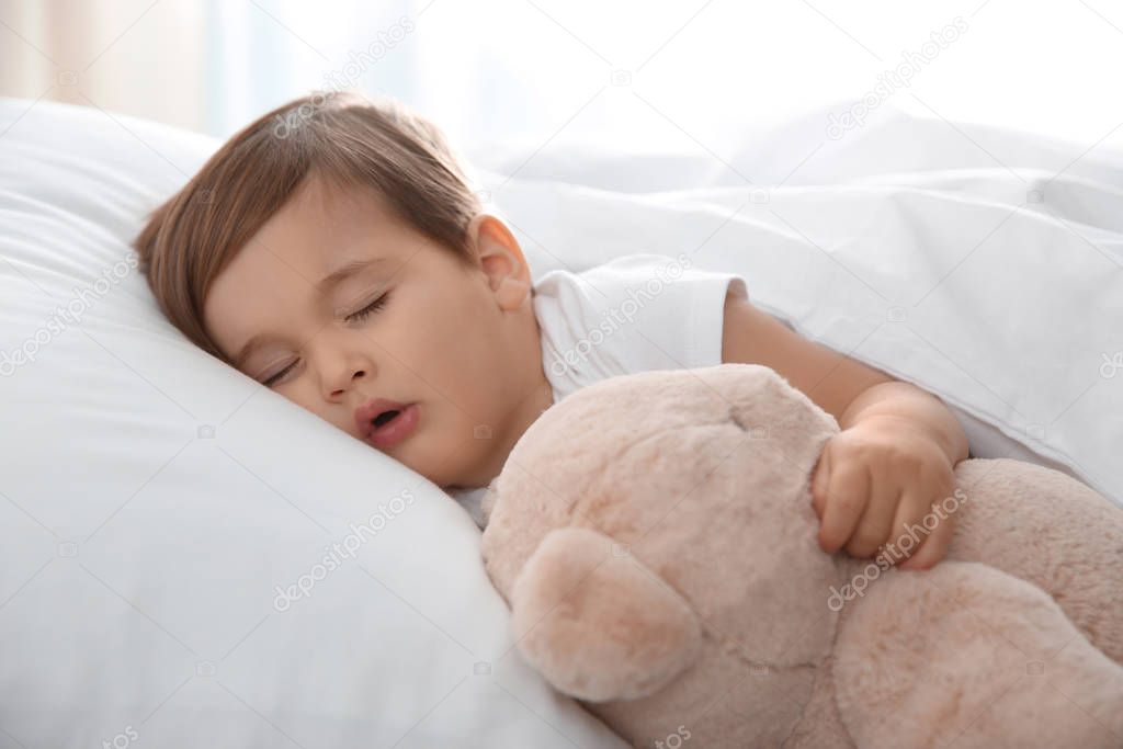 Cute little baby sleeping with toy at home. Bedtime